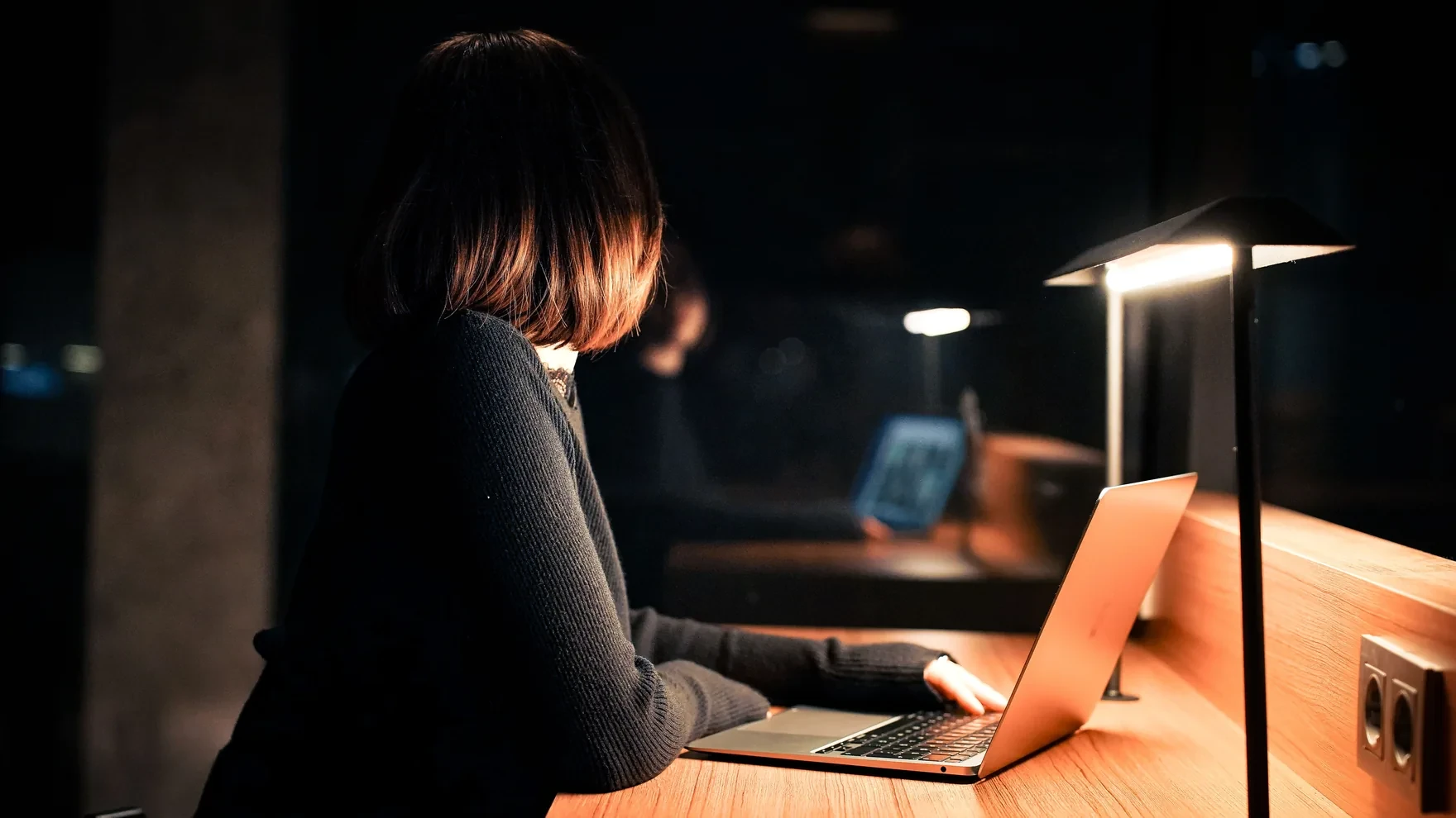 Marketers reviewing live performance dashboards with campaign metrics and analytics in a cinematic dark workspace